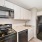 Kitchen with black appliances and white cabinets