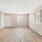 Bright living room with wall length window along the side.